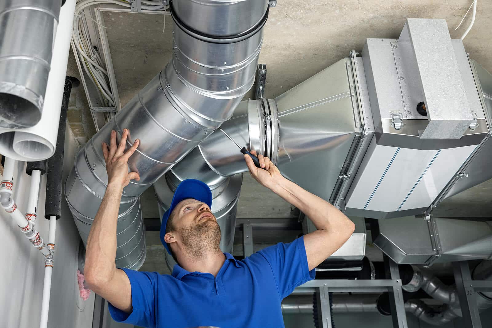 HVAC technician inspecting and repairing air ducts in Hawthorne