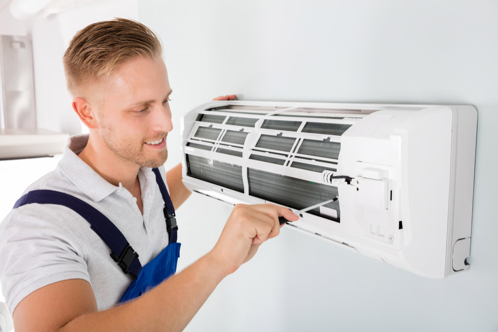 HVAC technician maintaining a ductless air conditioner in Hawthorne