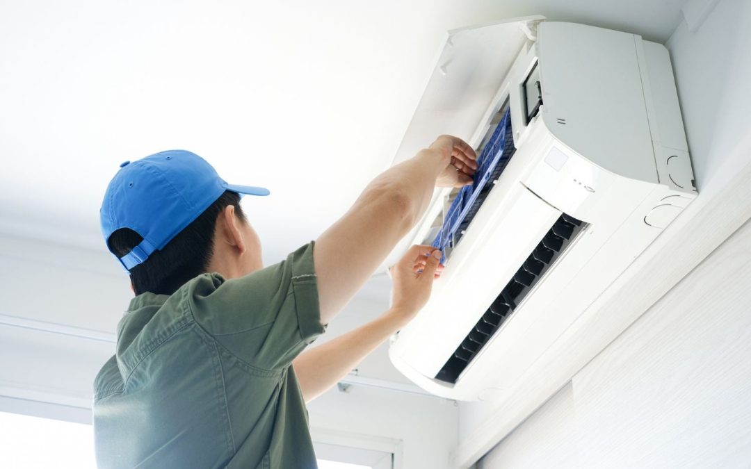 HVAC technician servicing a ductless mini split in Hawthorne