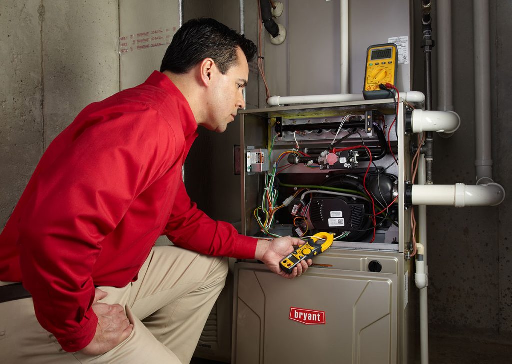Heating technician diagnosing a furnace repair in Hawthorne