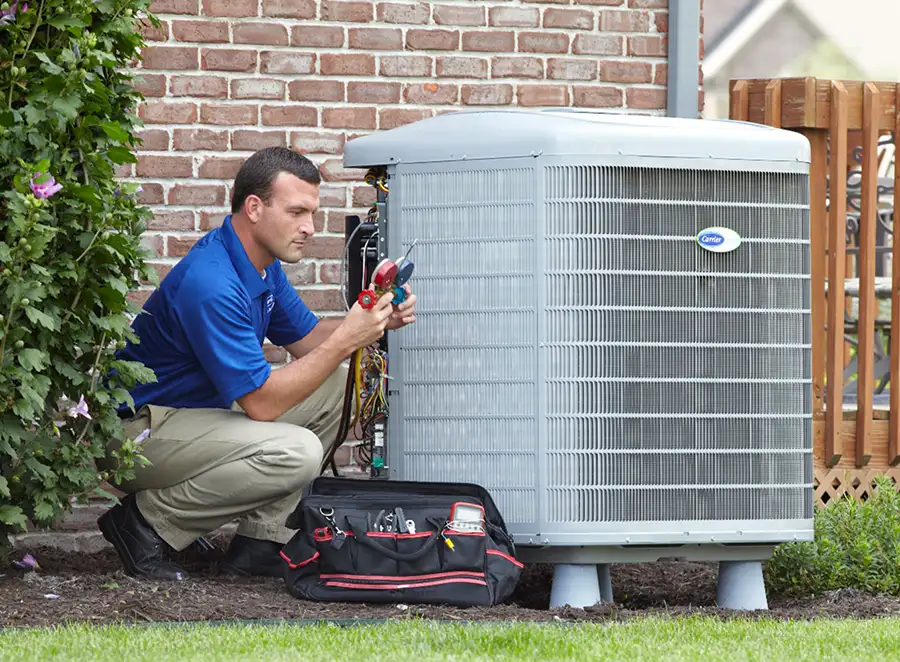 HVAC technician inspecting an outdoor AC unit in Hawthorne